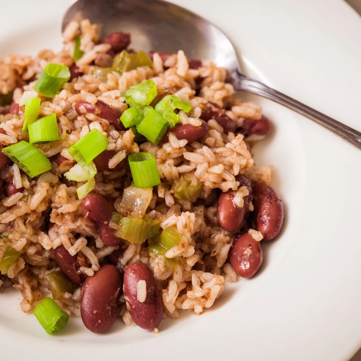 Earthy Cajun Red Beans and Rice simmering, ready to spoon over fluffy rice.
