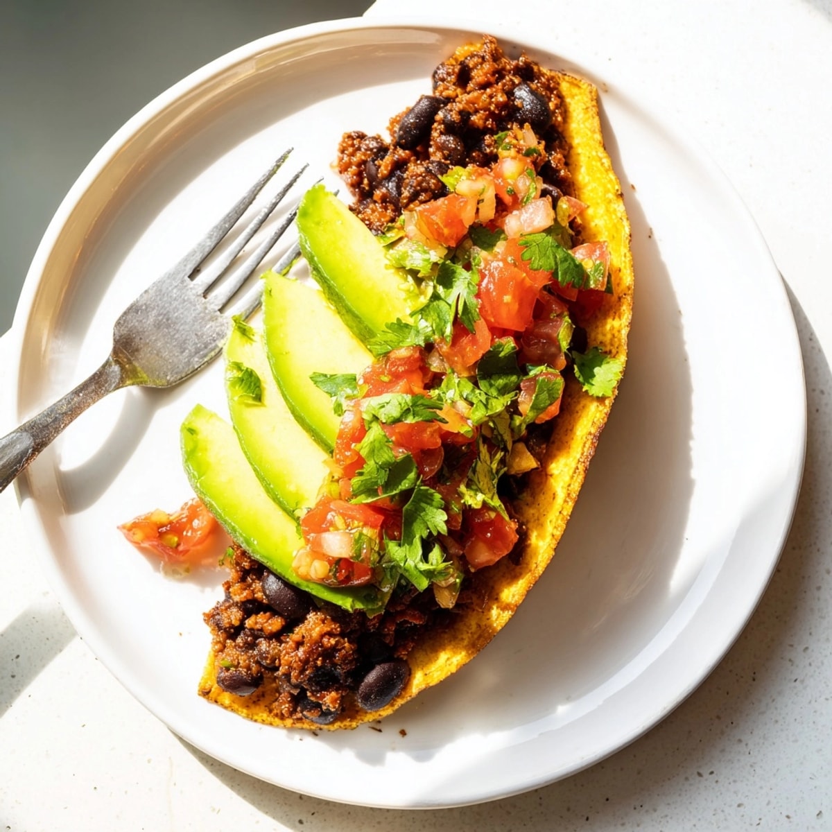 Black bean tacos bursting with smoky flavors, topped with cool, creamy avocado.