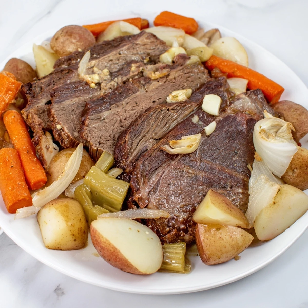 Hearty Sunday pot roast alongside golden potatoes and colorful root vegetables for flavor.  