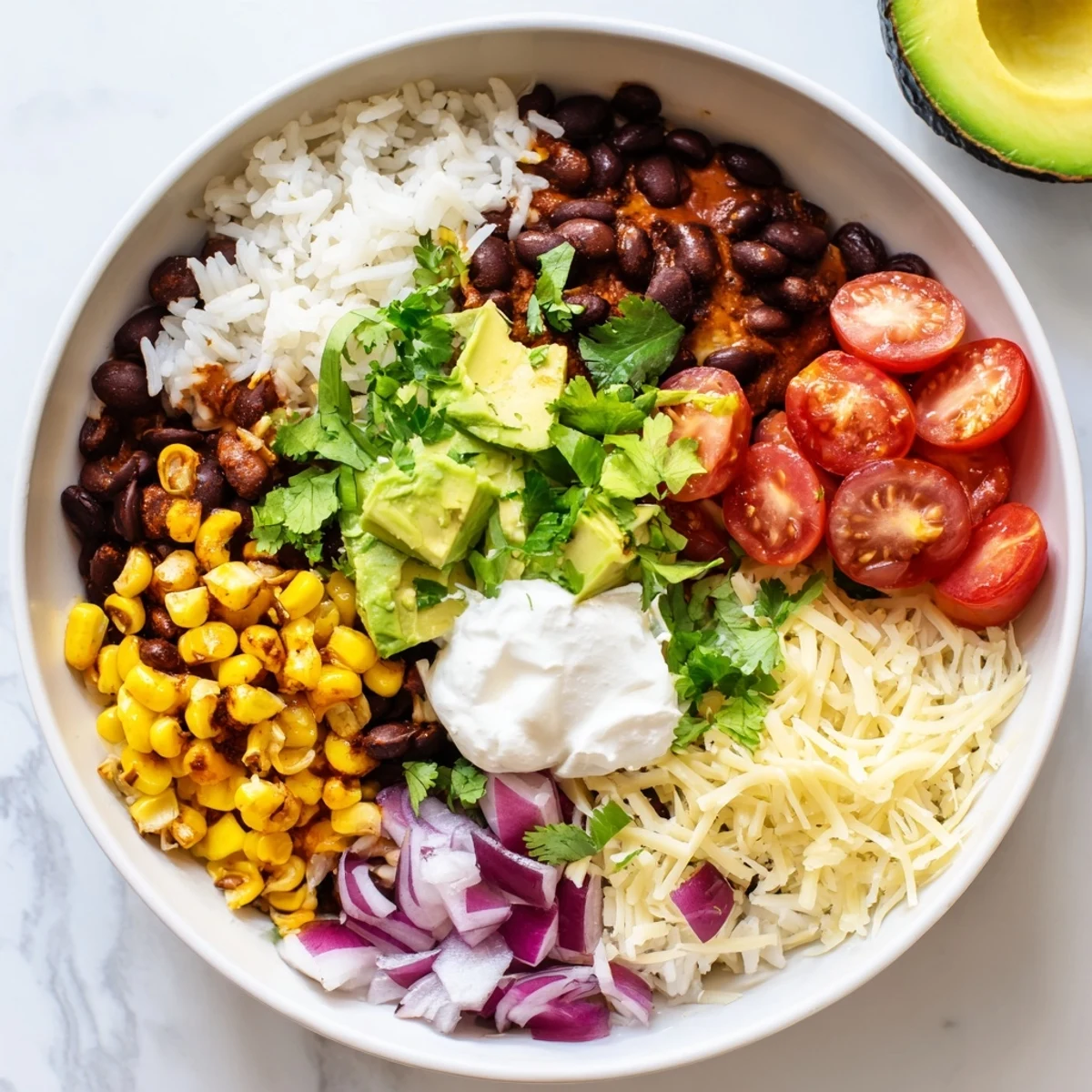 Fluffy rice, vibrant beans, and sweet corn make up this delicious Rice, Bean, and Corn Burrito Bowl meal.