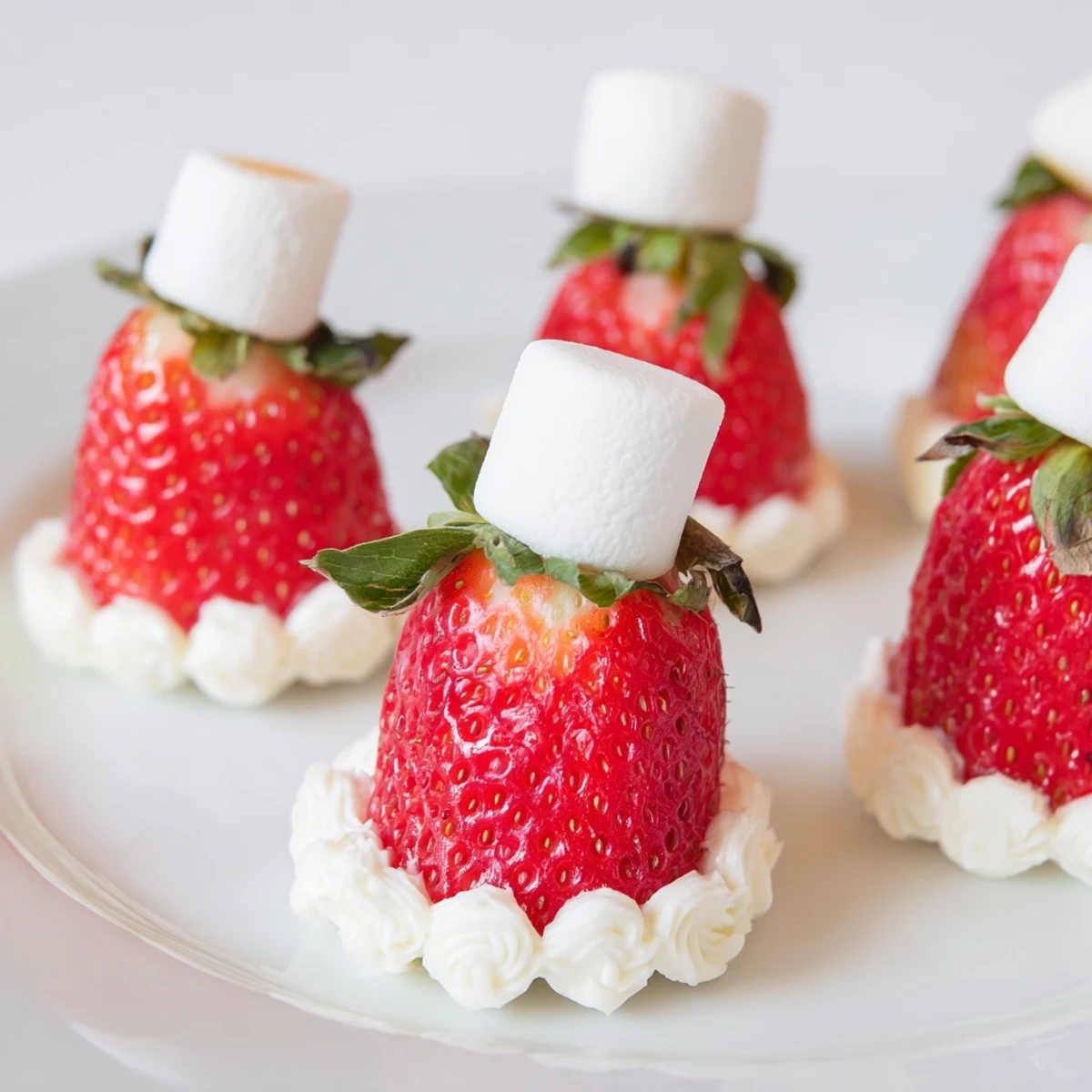 Bright red Air Fryer Santa Hat Strawberries, with fluffy white cheesecake filling, ready for a festive dessert.