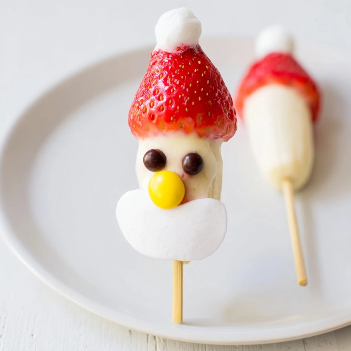 Delicious Banana Santa Snack Sticks: ripe banana slices with fresh strawberry hats are easy to make.