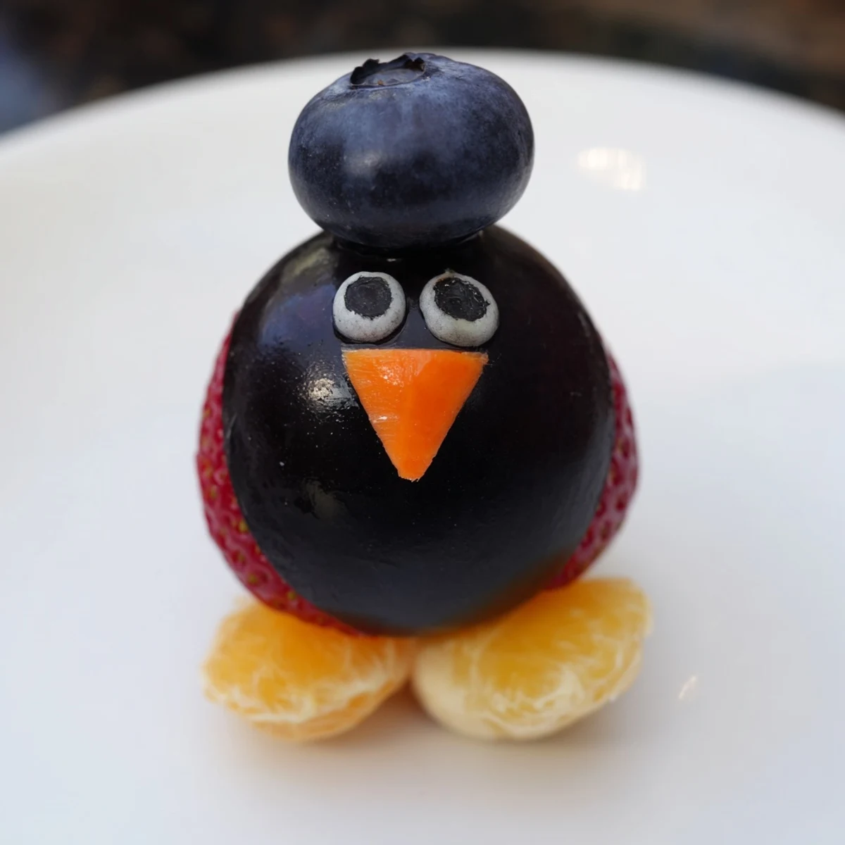 A playful Penguin Fruit Skewer Army makes a fun and colorful party snack for kids.