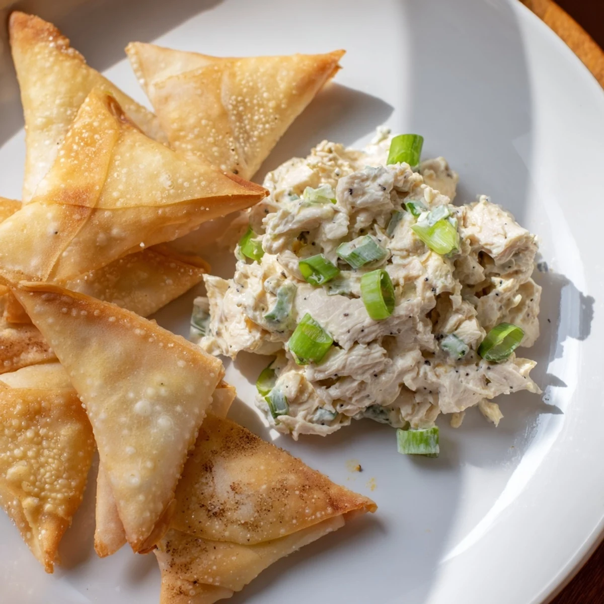 This plate features the savory air fryer lumpia chips, ready to dip into chicken cream cheese goodness.