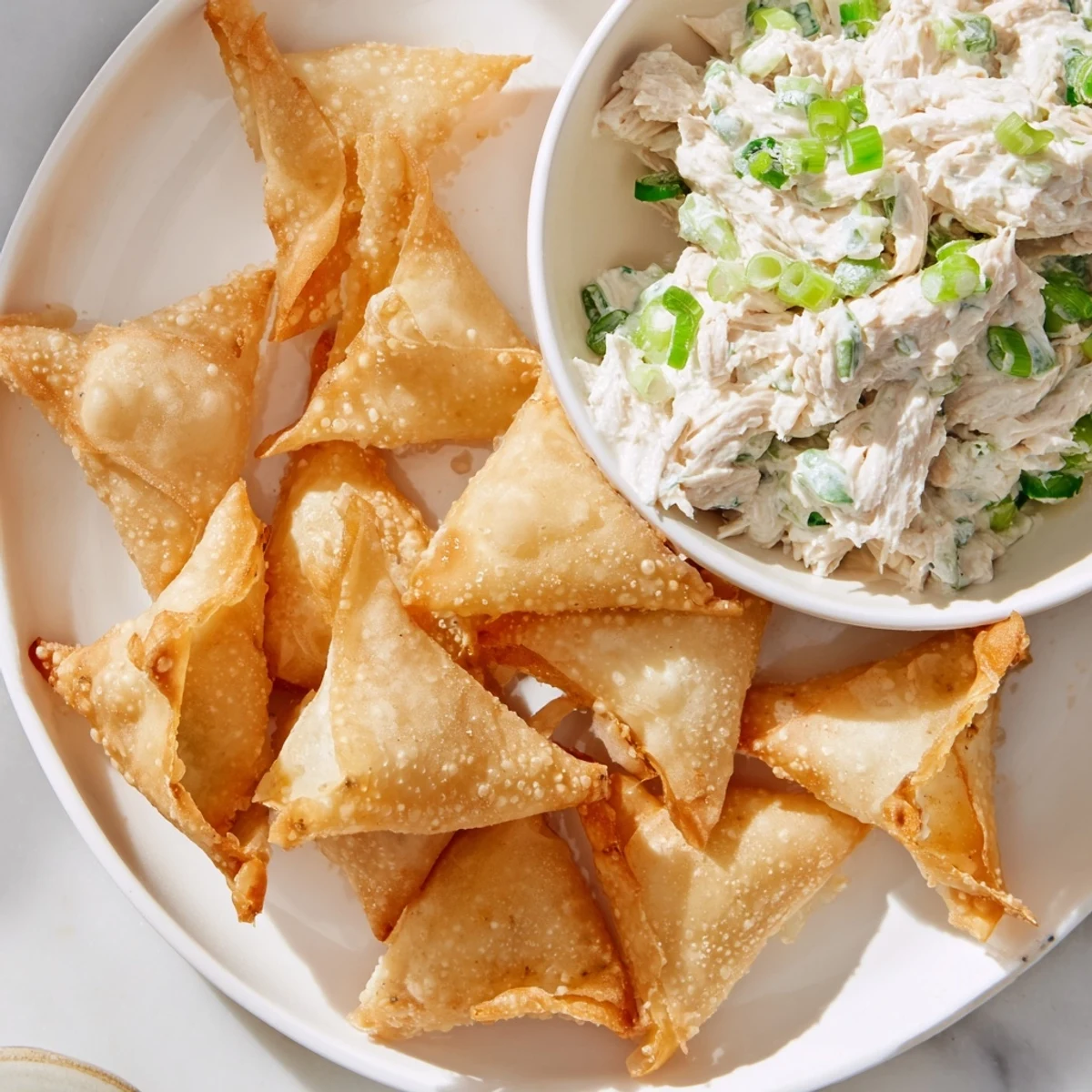 Quick and easy air fryer lumpia chips, ideal for dipping into flavorful chicken cream cheese dip with a Filipino twist.