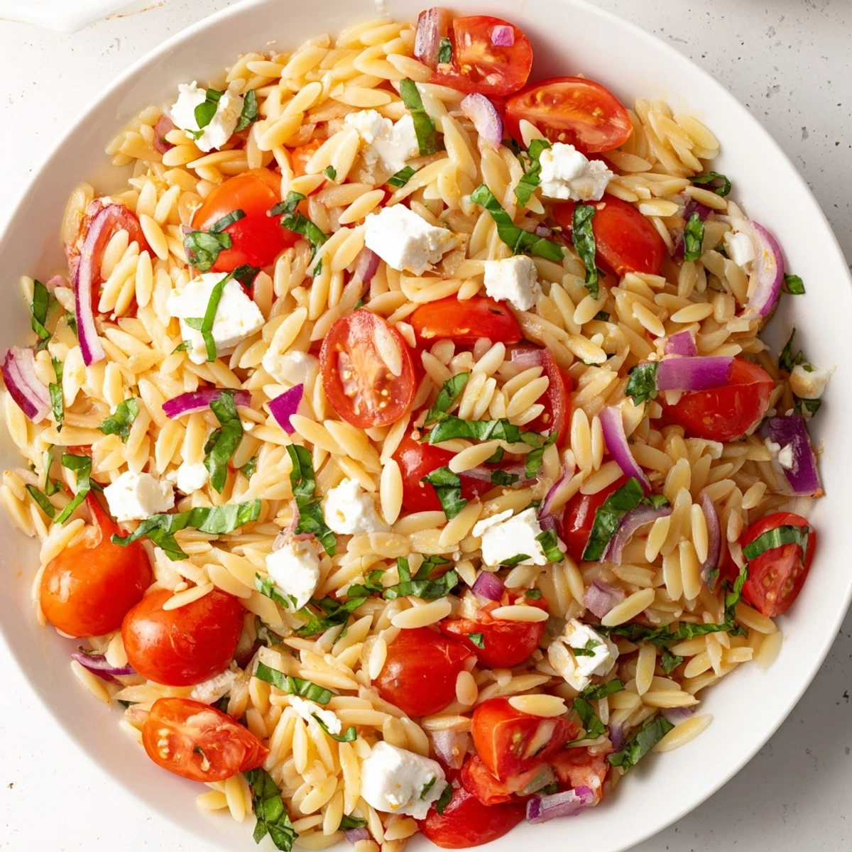 Bright and flavorful Tomato Feta Orzo: a delicious Mediterranean dish ready to serve.