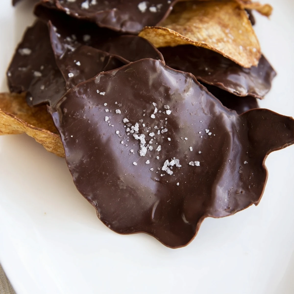 Crunchy potato chips covered in smooth, dark chocolate bark with sea salt – a delicious treat.