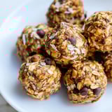 Homemade Almond-Chia Energy Bites stacked on a parchment paper lined baking sheet, ready to cool.