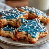 Delicate sugar cookies decorated with white icing to resemble the Pisces constellation, accented with edible gold pearls.