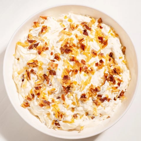 Golden caramelized onion and bacon dip, a creamy appetizer, ready for dipping and sharing.