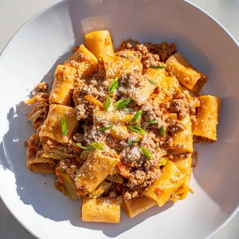 Chaos Cooking Kimchi Ragu Pasta, a vibrant plate of pasta coated in creamy, spicy, savory sauce.