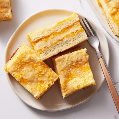 Golden-brown pancake bars filled with creamy cheese, perfect for a cozy breakfast treat.  