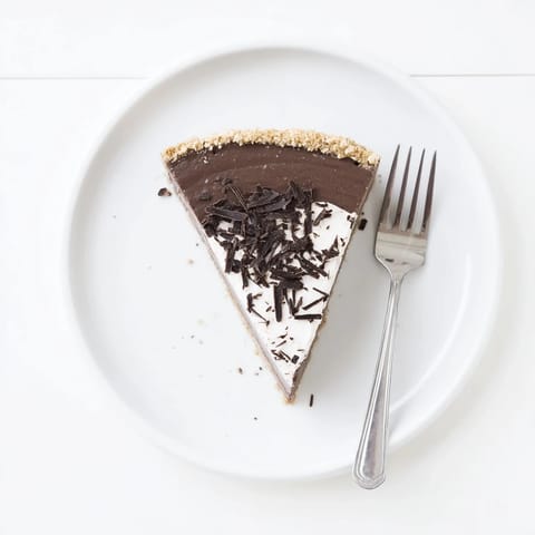 The baked Lighter Chocolate Cottage Cheese Cheesecake reveals a smooth, creamy texture and a dark cocoa hue in a springform pan.  