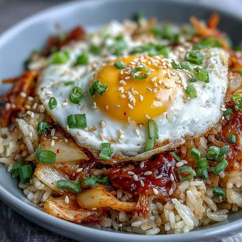 Kimchi cabbage fried rice with crispy napa cabbage, spicy kimchi, and a golden fried egg on top.  