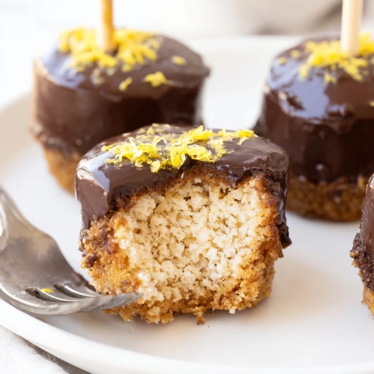 Bite-sized Lemon Ginger Smores Muffin Pops topped with gooey marshmallow and rich chocolate.  