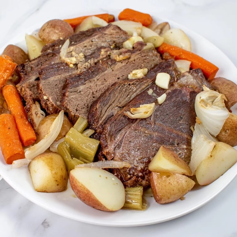 Hearty Sunday pot roast alongside golden potatoes and colorful root vegetables for flavor.  