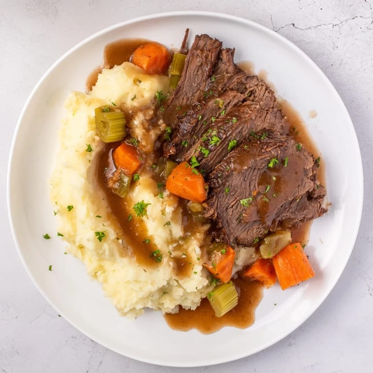 Fork-tender Slow Cooker Pot Roast with vibrant vegetables, swimming in a rich, savory gravy.