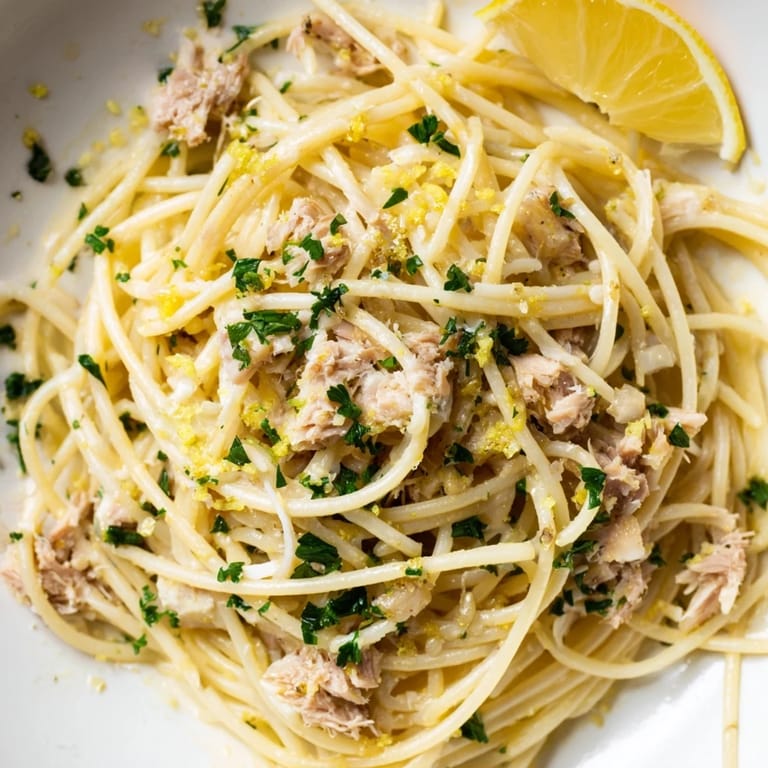 Bright, appetizing photo of Lemon-Garlic Tuna Spaghetti, showcasing the zesty lemon and tender tuna.
